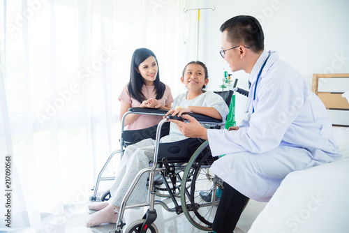 Young asian girl patient and mother smiling while doctor come to visit