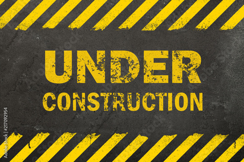 Concrete background with under construction sign