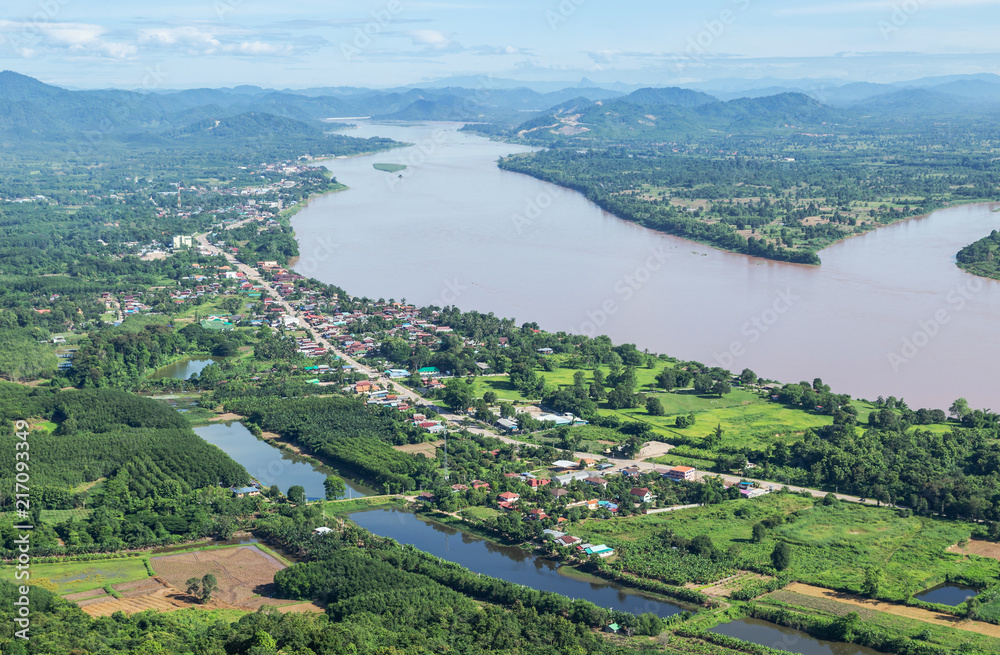 High angle view of Sangkhom district from viewpoint skywalk at Wat Pha Tak Suea , Nong Khai province ,Thailand with Mekong river between border thai - Laos People's Democratic Republic 