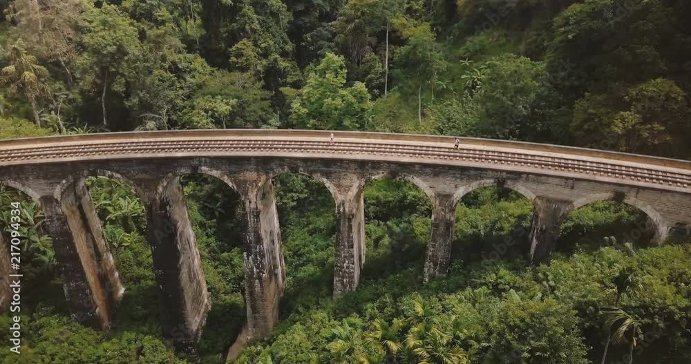 Drone flying left opening beautiful panoramic view of Nine Arch Bridge Ella in Sri Lanka, historic architecture landmark Drone flying left opening beautiful panoramic view of Nine Arch Bridge Ella in Sri Lanka, historic architecture landmark