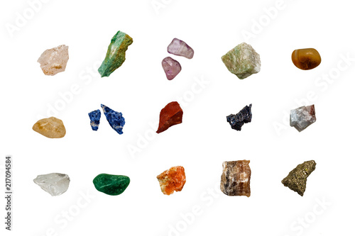various colored raw gemstones fragments on white background