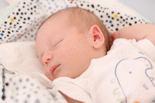 Sleeping small baby on bright background