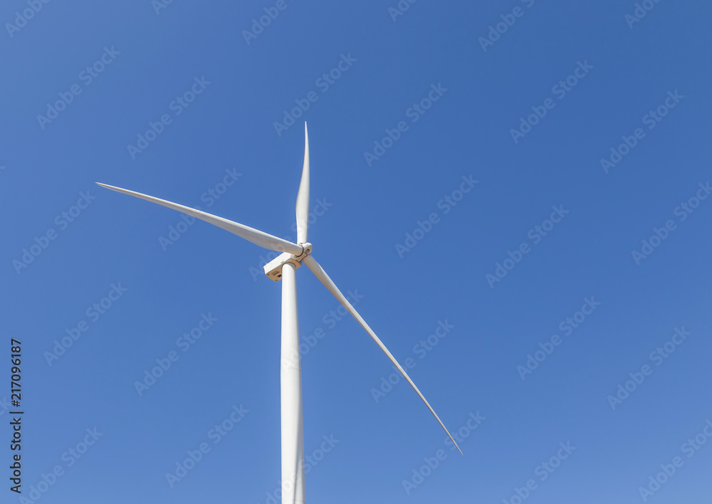 close up white wind turbine generating electricity producing in wind power station alternative energy with blue sky close up white wind turbine generating electricity producing in wind power station alternative energy with blue sky