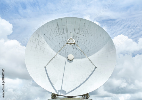 Fototapeta Naklejka Na Ścianę i Meble -  Big large white satellite dish turn up skyward on blue sky in earth communication antenna system center station