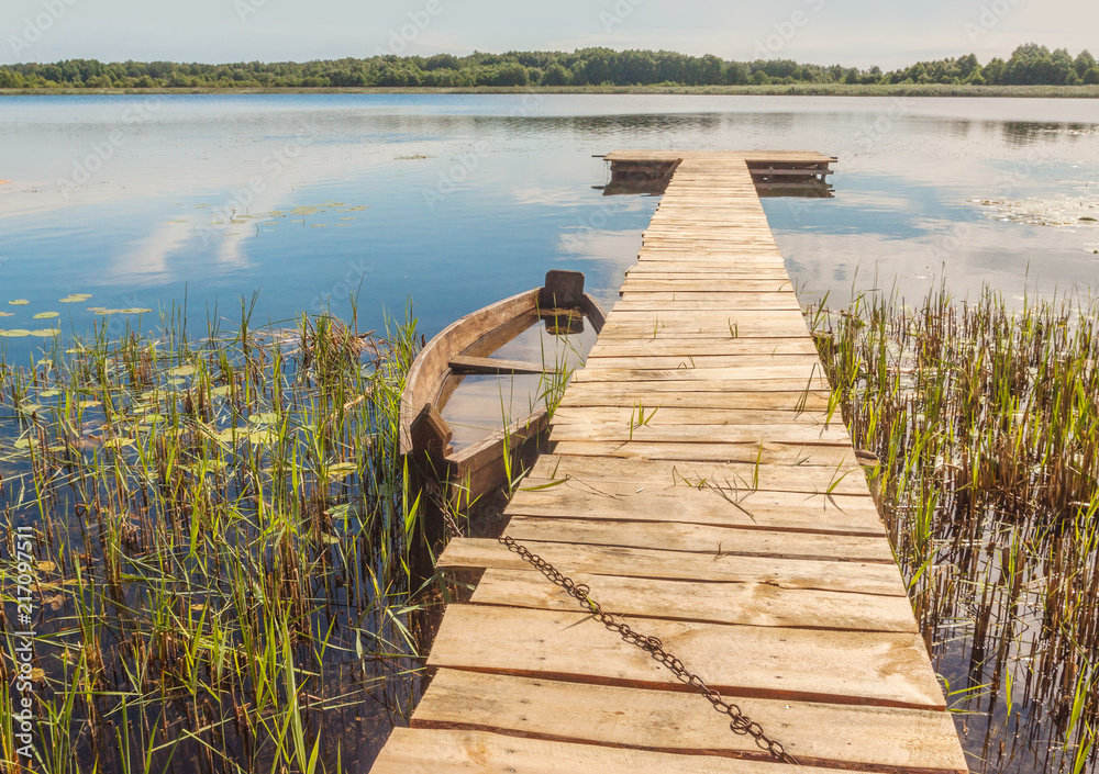 Naklejka premium Old boat on the lake Svitiaz
