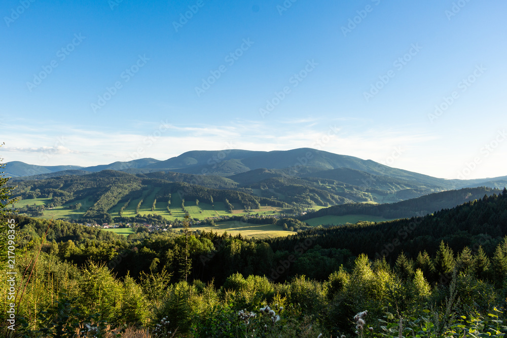 Fototapeta premium Majestic landscape of mountains and Meadow. Cycling mountain road. Misty mountain road in high mountains.. Cloudy sky with mount