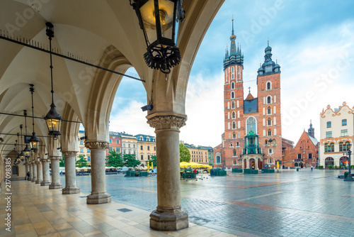 Beautiful open view of the main square of Krakow. Mary's church and arch in cloudy weather