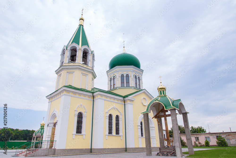 church with green domes on the blue sky background
