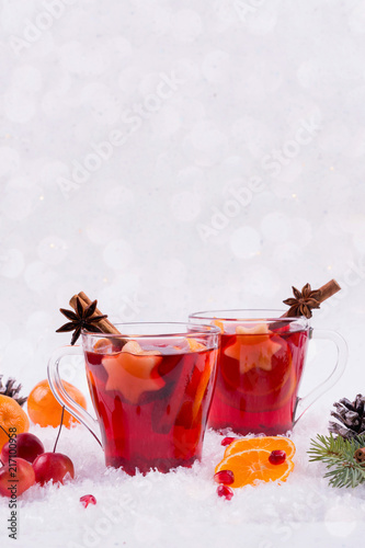 Christmas mulled wine and ingredients. On white snow background with copyspace