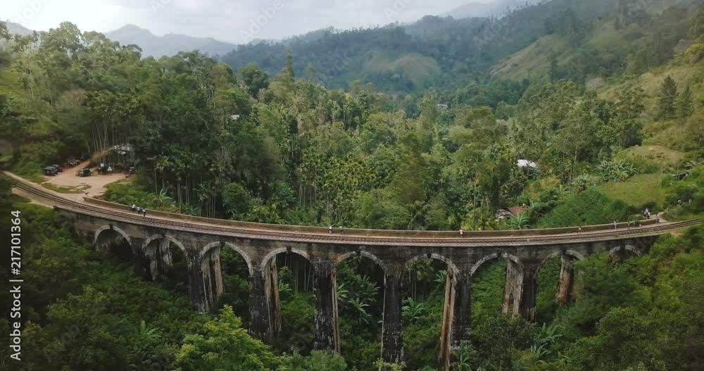Drone flying backwards and rising to reveal breathtaking panoramic aerial view of Nine Arch Bridge Ella in Sri Lanka. Drone flying backwards and rising to reveal breathtaking panoramic aerial view of Nine Arch Bridge Ella in Sri Lanka.