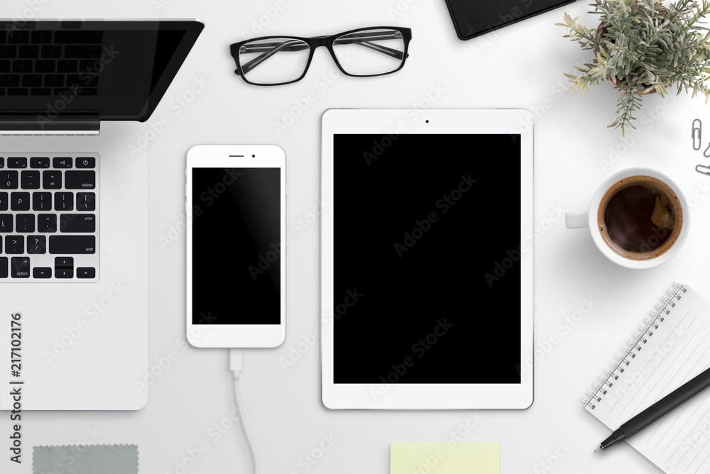 Smart phone and tablet mockup. Office desk with laptop computer, glasses, cup of coffee, notepad and plant. Flat lay. Smart phone and tablet mockup. Office desk with laptop computer, glasses, cup of coffee, notepad and plant. Flat lay.