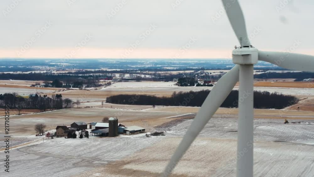 Incredibly cinematic aerial view of windmills in the countryside on a cloudy day. Incredibly cinematic aerial view of windmills in the countryside on a cloudy day.