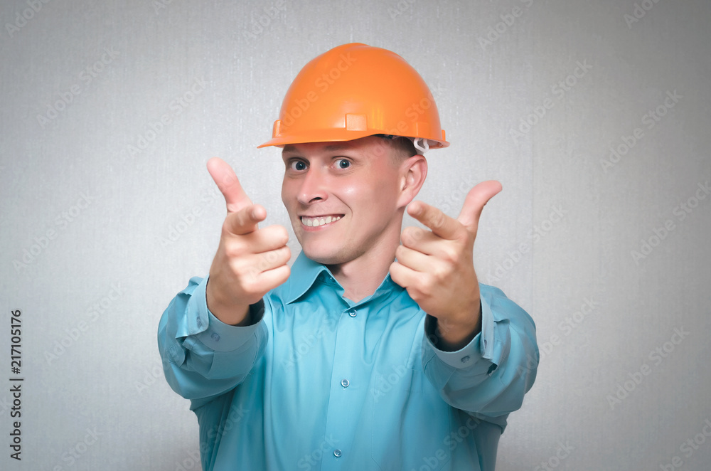 Successful builder worker man closes his eyes from happiness. Worker won a contract for construction and repair isolated on gray background.