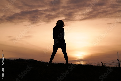 mysterious people on a hill at sunset