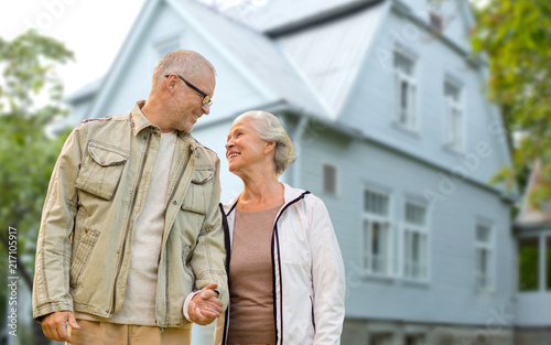 Photography old age, accommodation and real estate concept - happy senior couple holding han
