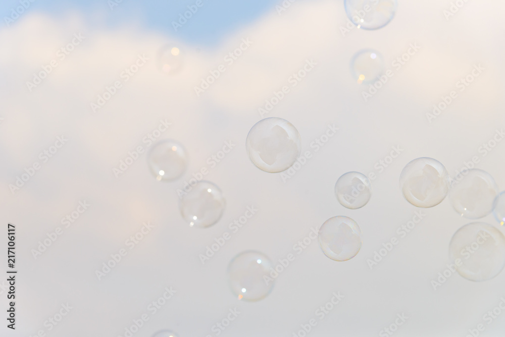 Soap bubbles in the air with cloud and blue sky on background, Outdoor activity funny and party