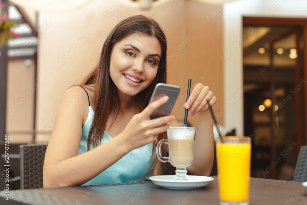 Portrait of beautiful girl using her mobile phone in cafe Portrait of beautiful girl using her mobile phone in cafe