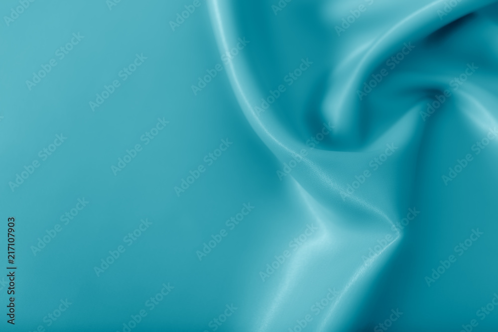 Smooth elegant shiny turquoise silk or satin luxury cloth texture can use as abstract holidays background. Luxurious Christmas background or New Year background design.