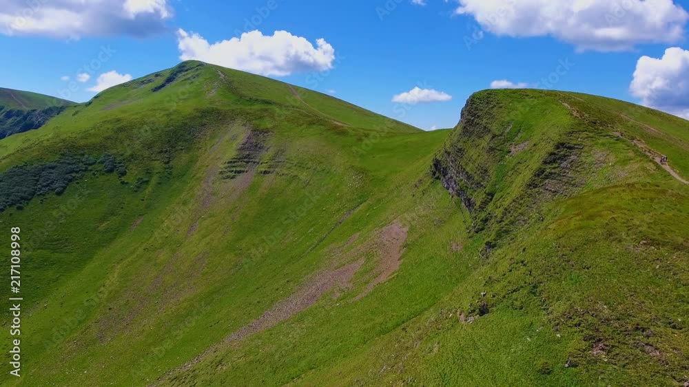 Aerial shot of two peaks with sharp slopes in the Carpathian Mountains in summer Aerial shot of two peaks with sharp slopes in the Carpathian Mountains in summer