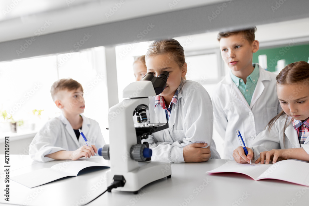 education, science and children concept - kids or students with microscope studying biology at school laboratory education, science and children concept - kids or students with microscope studying biology at school laboratory