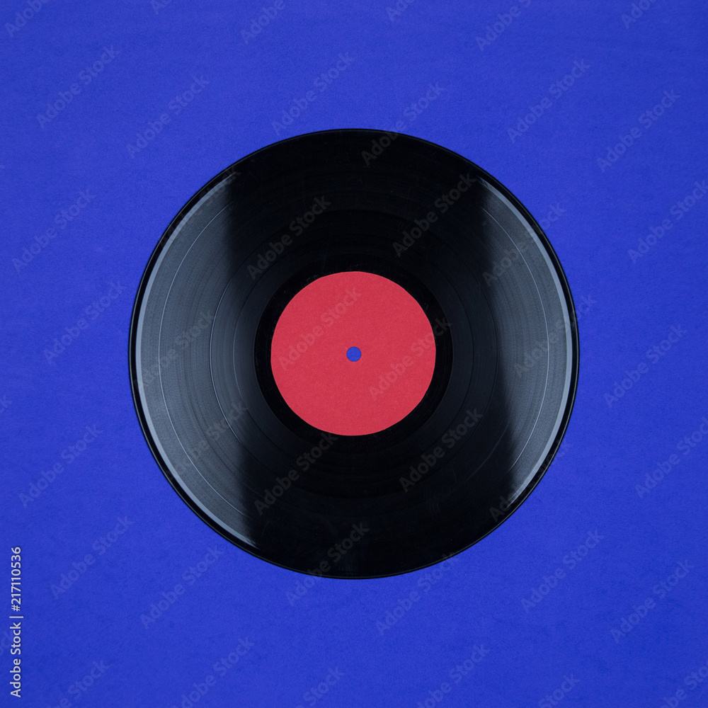 Obraz premium Closeup of Vinyl Long Play Record with Label with Copy Space on blue background
