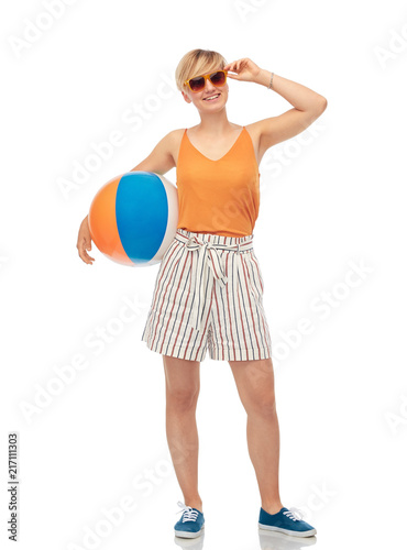 leisure, summer holidays and people concept - smiling teenage girl in sunglasses with beach ball over white background