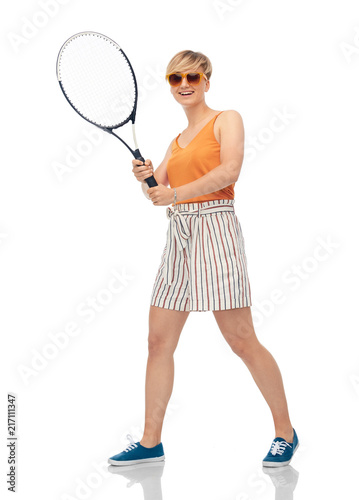 sport, leisure and people concept - smiling teenage girl with racket playing tennis over white background © Syda Productions