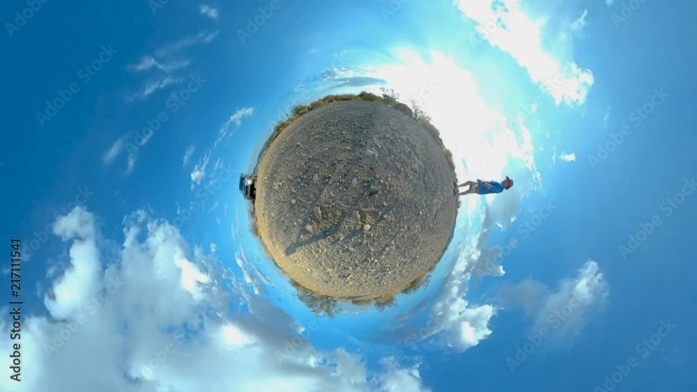 Man walking around a tiny planet with a beautiful sky. Can be used vertical or horizontal.