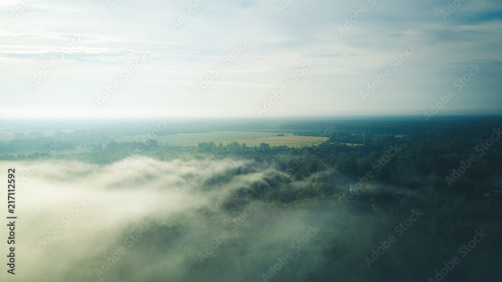 Misty sunrise over countryside path Aerial view Latvia