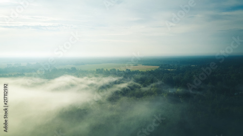 Fototapeta Naklejka Na Ścianę i Meble -  Misty sunrise over countryside path Aerial view Latvia