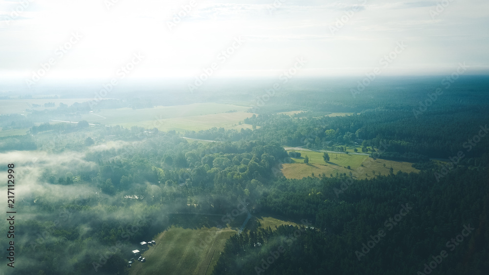 Misty sunrise over countryside path Aerial view Latvia