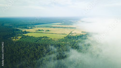 Misty sunrise over countryside path Aerial view Latvia