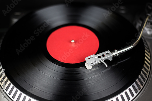 Professional turntable close-up. Analog stage audio equipment for concert in nightclub. Play mix music tracks on vinyl records. Turntables needle cartridge scratches vinyl disc. DJ setup for festival