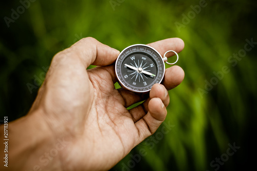 compass in a hand at the jungle.