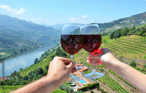 Wine glasses against vineyards in Douro Valley, Portugal