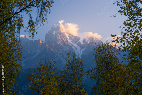 Autumn Landscape with birch forest and mountain peak Ushba photo