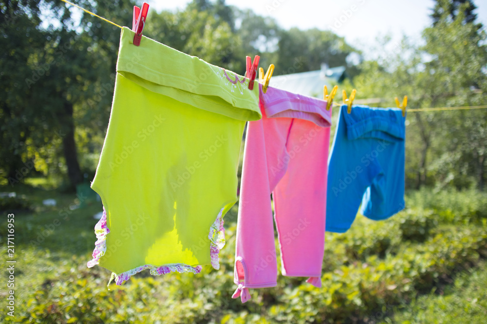 colorful baby clothes hanging on a line