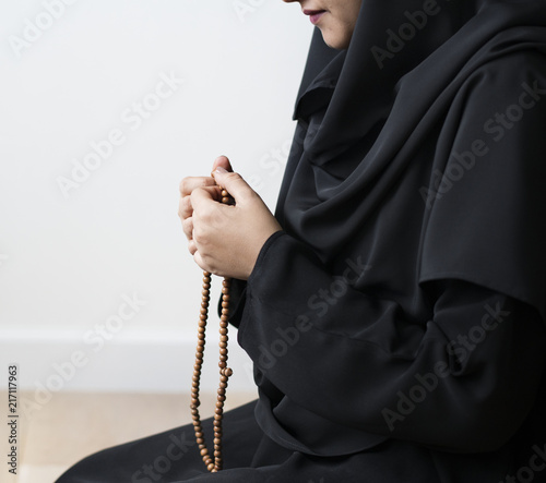 Muslim women using misbaha to keep track of counting in tasbih photo