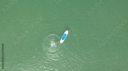 Birdseye view of man on Stand Up Paddle falling