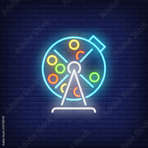 Neon icon of lottery drum. Lotto machine with balls inside on brick wall background. Lottery game concept. Can be used for neon signs, posters, billboards, banners