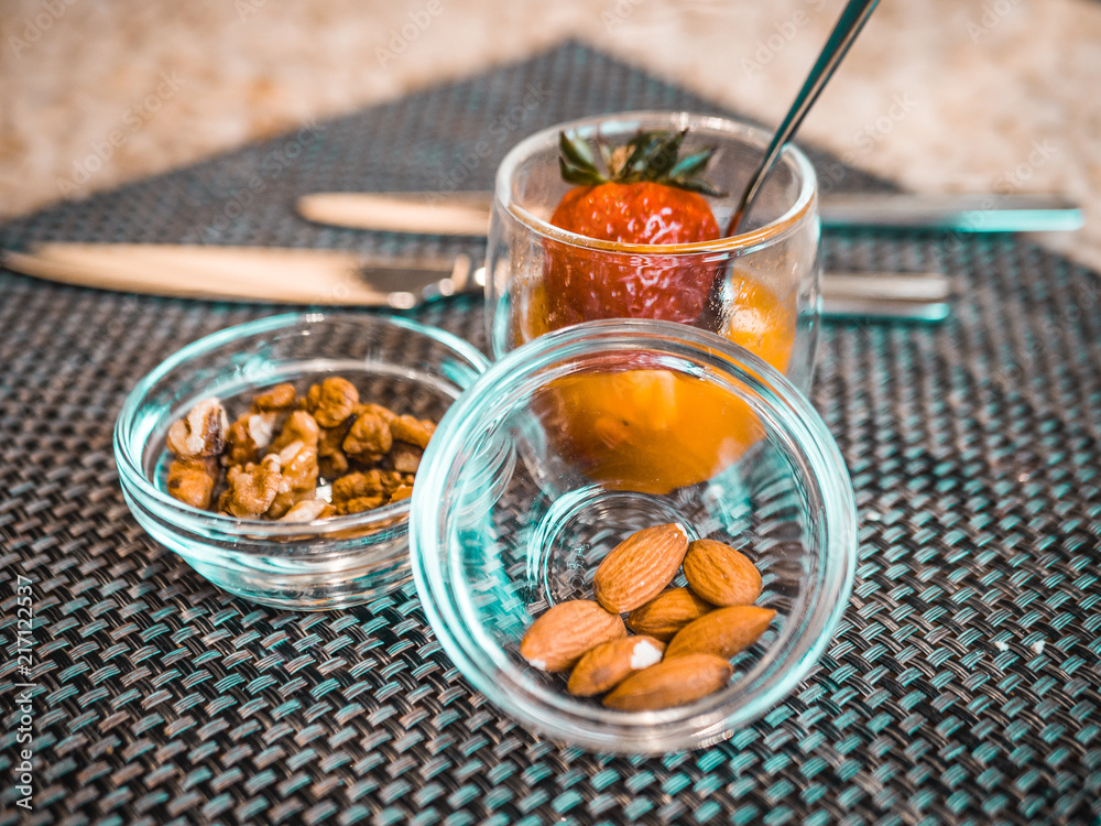 Nuts and strawberries in glass bowls. delicious snacks for breakfast in the hotel restaurant