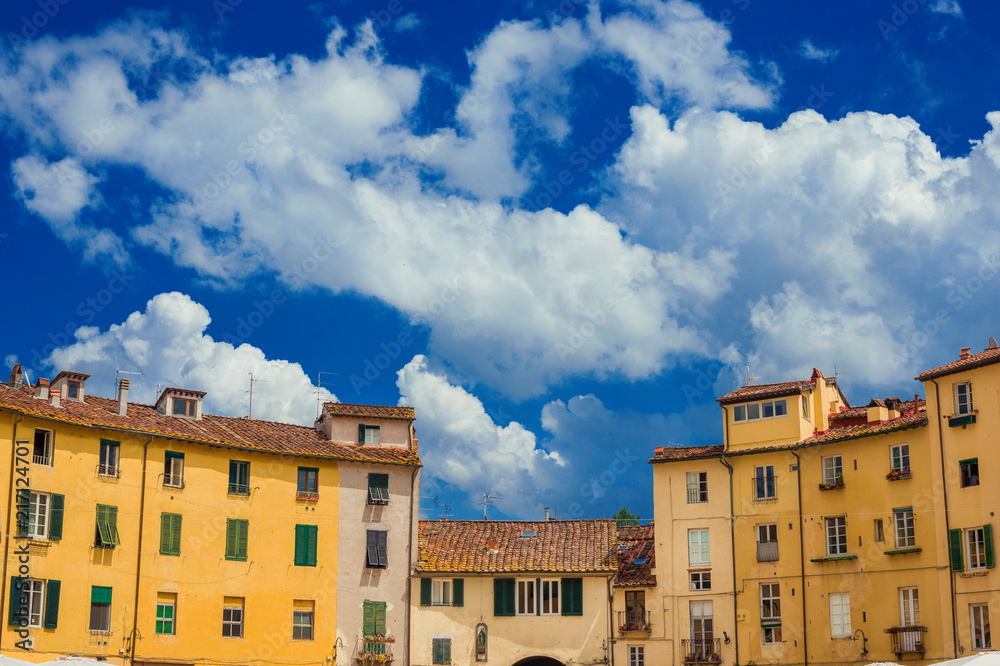 Beautiful clouds over the famous Piazza dell'Anfiteatro (Amphitheater Square) in the historic center of Lucca, with houses built over ancient roman arena ruins