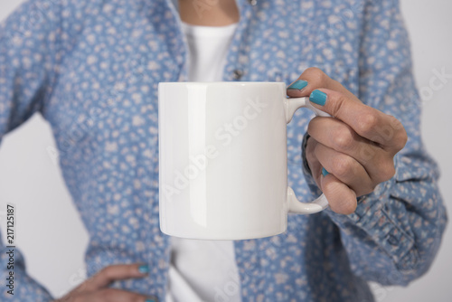Hand Holding White coffee cup. mockup for creative design branding.