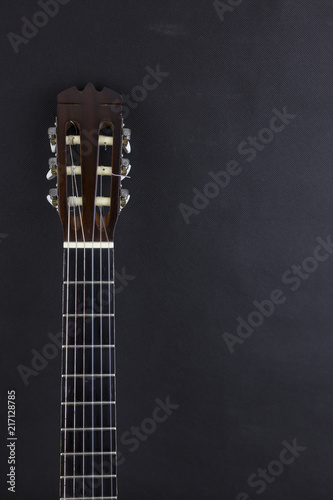 guitar neck orange acoustic guitar on black background.