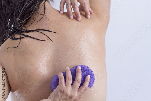 A woman cleaning her back