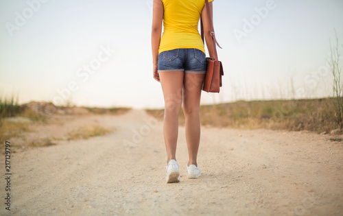 Girl walking on a path in the countryside