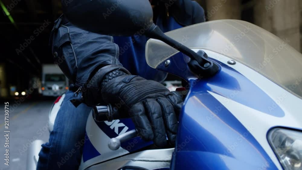 SLOW MOTION video of motorcyclist reaching for front hand grip on motorcycle wearing leather glove SLOW MOTION video of motorcyclist reaching for front hand grip on motorcycle wearing leather glove