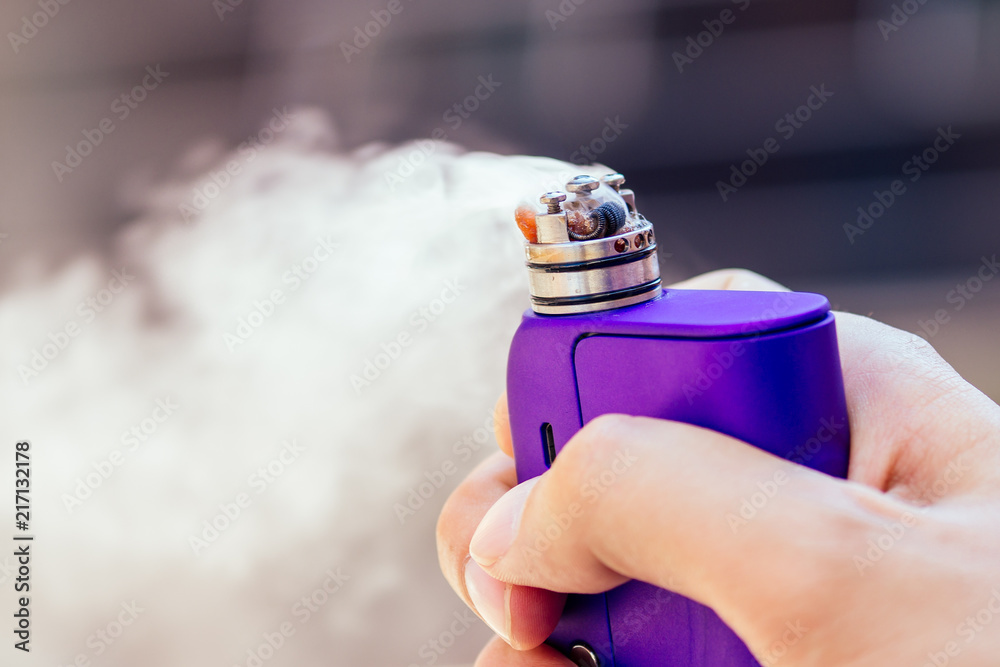 purple vape in a man's hand on a modern background Stock Photo Adobe Stock