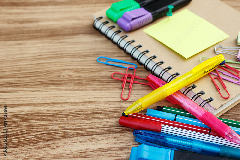 Fototapeta premium School supplies on a wooden table with space for text