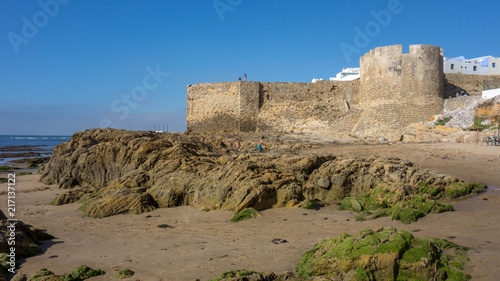 Asilah beach and wall of the medina, Morocco.